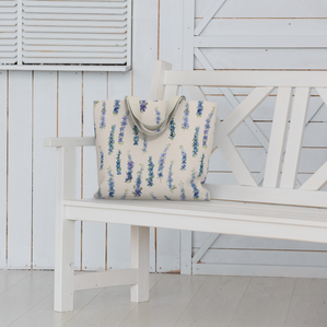 Weekender Tote with Dancing Delphinium on Cream pattern on a bench