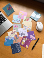 Colorful mini desk calendar on a desk with a laptop and mouse.