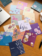 mini desk calendar spread out on a  wooden desk