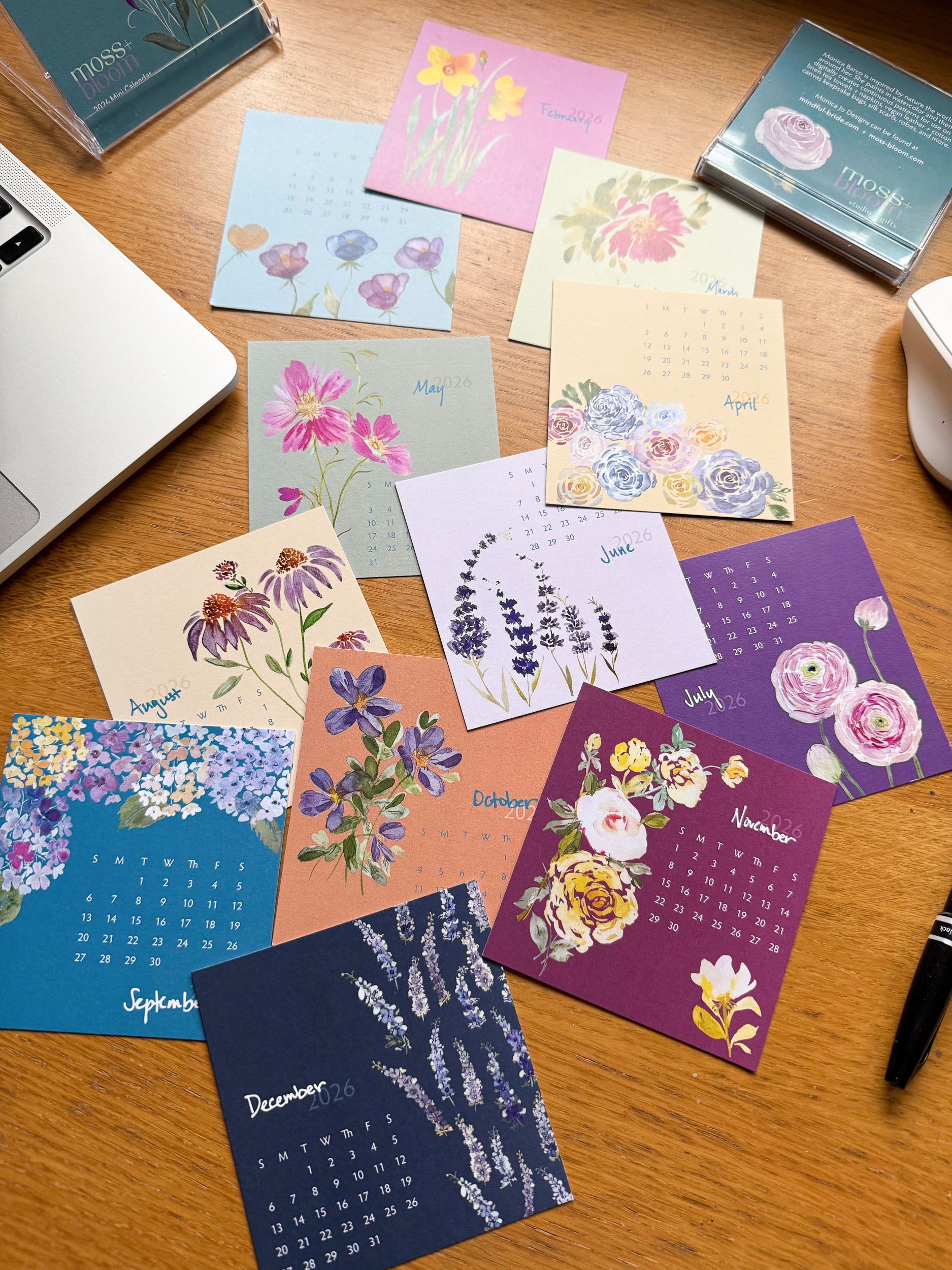mini desk calendar spread out on a  wooden desk