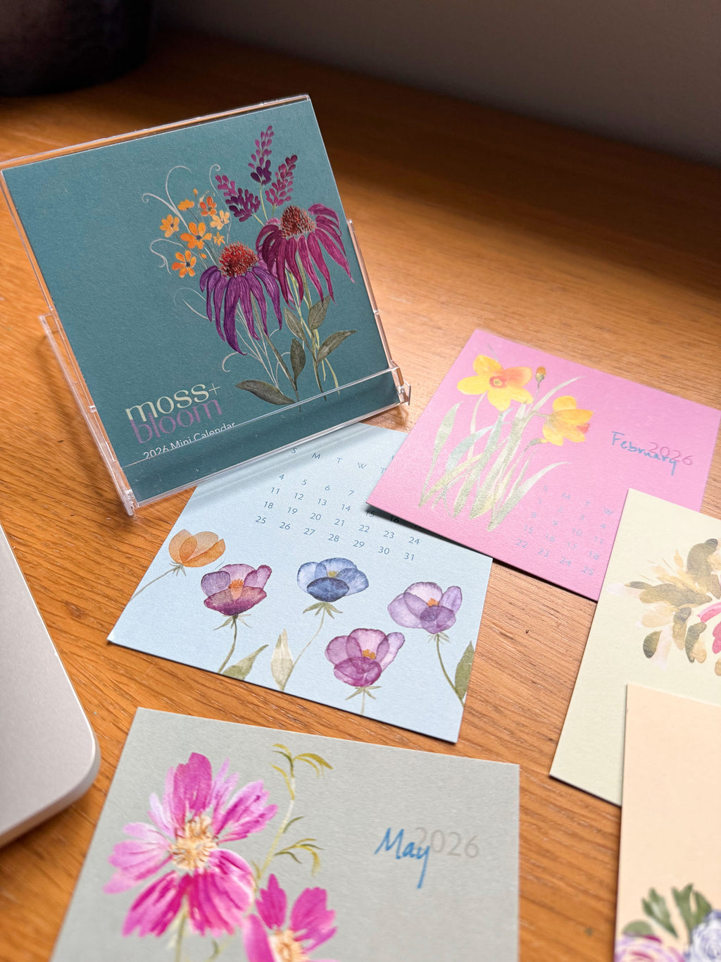 A colorful mini desk calendar on a wooden surface