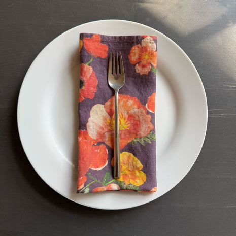 European Linen napkin with an Ember Poppies pattern on elderberry
