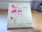 Small calendar featuring a cosmos floral painting with May 2026 calendar