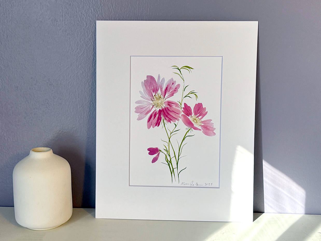 Framed floral artwork with pink flowers on a gray wall background